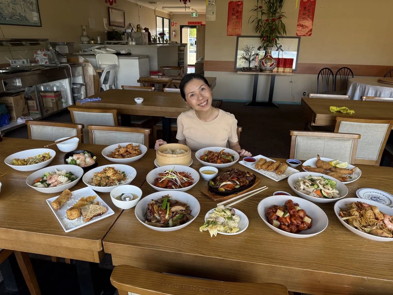 The dining room at Warner Chinese Restaurant with timber tables and Chinese calligraphy