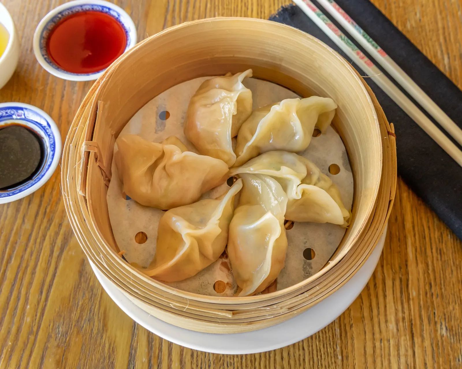 Handmade dumplings arranged in a bamboo steamer