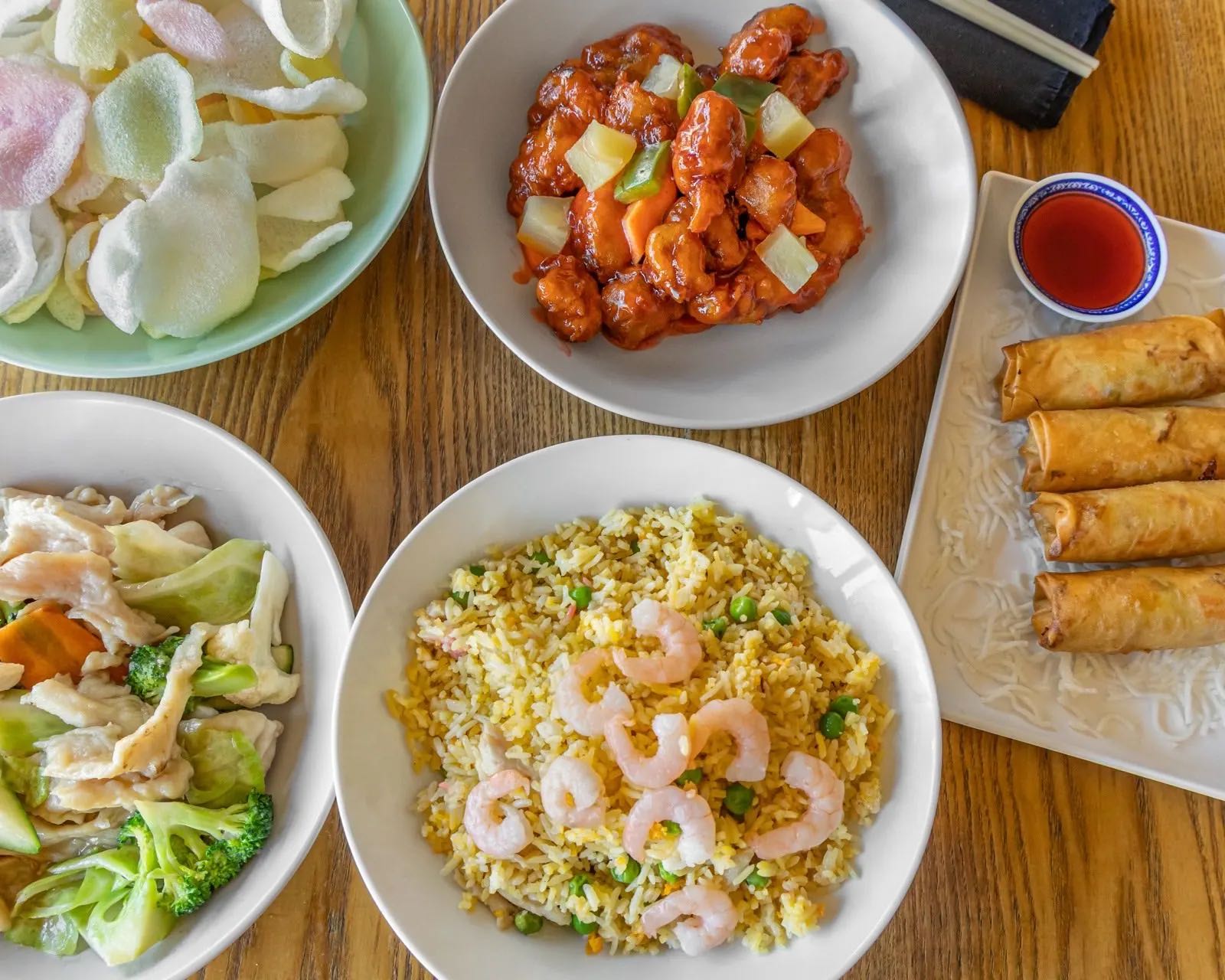 Family pack spread with fried rice, sweet and sour pork and spring rolls